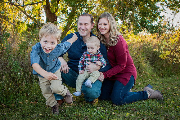 Family laughs in park for mini session