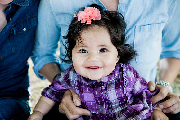 Smiling baby looks at camera with smile