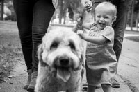 Child and dog in park smiling