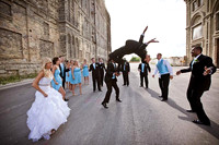 Jumping Bridal Party Photo in City Alley